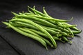 Fresh green string beans arranged on black background in high contrast close-up Royalty Free Stock Photo