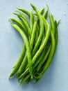 Fresh green string beans with water droplets on a light textured background Royalty Free Stock Photo