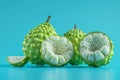 Fresh Green Sugar Apples Sweetsop on Blue Background, Exotic Tropical Fruit Display with One Cut Open