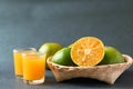 Green tangerine fruit in bamboo basket and juice Royalty Free Stock Photo