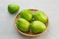 Fresh green tomatoes on bamboo plate. Royalty Free Stock Photo