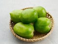 Fresh green tomatoes on bamboo plate. Royalty Free Stock Photo