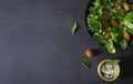 Fresh green vegetable salad. Top view from above of cherry tomato, basil with spinach and lettuce, red cabbage in black bowl on da Royalty Free Stock Photo