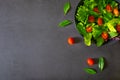 Fresh green vegetable salad. view from above of cherry tomato, basil, spinach and lettuce, red cabbage in black bowl. Homemade, di Royalty Free Stock Photo