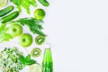 Fresh green vegetables, fruits and green smoothie in bottle. Top view with copy space. Royalty Free Stock Photo