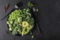 fresh green vegetables with herbs and spices on a dark background Royalty Free Stock Photo