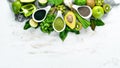 Fresh green vegetables in a rustic white background. Avocado, kiwi, onion, lime, parsley. Organic food. Rustic style.