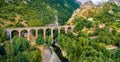 Fresh green view from flying drone of ancient bridge across the Devil`s Throat Gorge, San Severino village location.