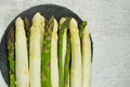 Fresh green and white asparagus on the black stone board and grey background Royalty Free Stock Photo