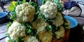 fresh green and white cauliflowers kept into the vegetables container Royalty Free Stock Photo