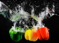 Fresh green, yellow and red bell peppers with water splash and bubble isolated. colorful copy space. Royalty Free Stock Photo