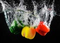 Fresh green, yellow and red bell peppers with water splash and bubble isolated. colorful copy space. Royalty Free Stock Photo