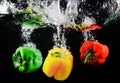 Fresh green, yellow and red bell peppers with water splash and bubble isolated. colorful copy space. Royalty Free Stock Photo