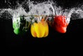 Fresh green, yellow and red bell peppers with water splash and bubble isolated. colorful copy space. Royalty Free Stock Photo