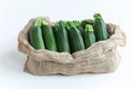 Fresh green zucchini in burlap sack on white background Royalty Free Stock Photo