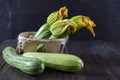 Fresh zucchini with flowers in a basket on a wooden table. Royalty Free Stock Photo