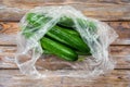 Cucumbers in plastic packaging on a wooden table Royalty Free Stock Photo