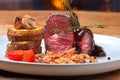 Fresh grilled bbq beef meat rib eye steak on white plate with baked potatoes, mushrooms, tomatoes,fried onion, hot chili pepper Royalty Free Stock Photo