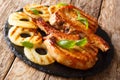 Fresh grilled pork chop steak in honey glaze with fried pineapples close-up on a slate board on a table. horizontal Royalty Free Stock Photo