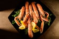 Fresh grilled shrimps served on a plate with arugula or rocket and llemon