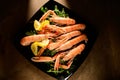 Fresh grilled shrimps served on a plate with arugula or rocket and llemon Royalty Free Stock Photo