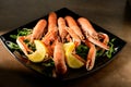 Fresh grilled shrimps served on a plate with arugula or rocket and llemon Royalty Free Stock Photo