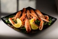 Fresh grilled shrimps served on a plate with arugula or rocket and llemon Royalty Free Stock Photo