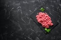 Fresh ground beef on a black stone background. Raw minced meat. Top view, flat lay, copy space Royalty Free Stock Photo
