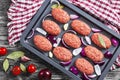 Fresh ground raw meat cutlets in baking dish