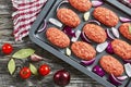 Fresh ground raw meat cutlets in baking dish