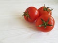 Fresh tomatoes whole nutritious bio diet on white wooden table cooking, ingredient