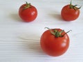 Fresh tomatoes whole nutritious bio on white wooden table cooking, ingredient