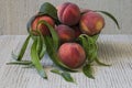 Fresh group of peaches and leaves on wooden background in the garden Royalty Free Stock Photo