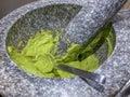 Fresh guacomole in a stone mortar Royalty Free Stock Photo