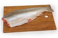 Fresh gutted uncooked arctic char without head on cutting board Royalty Free Stock Photo