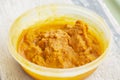 Fresh haldi turmeric paste to be applied on Hindu bride.