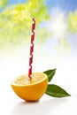 Fresh half orange with drinking straw on white background Royalty Free Stock Photo