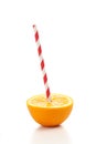 Fresh half orange with drinking straw Royalty Free Stock Photo