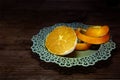Fresh half orange and a peel strip on dark wood Royalty Free Stock Photo
