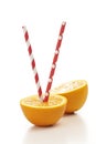 Fresh half oranges with drinking straw on white background Royalty Free Stock Photo