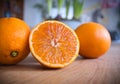 Fresh halfed orange fruit on a wooden table Royalty Free Stock Photo