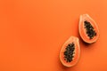 Fresh halved papaya fruit on orange background, flat lay. Space for text Royalty Free Stock Photo