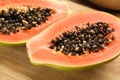 Fresh halved papaya fruit on wooden board, closeup Royalty Free Stock Photo