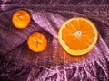 Fresh halves and whole oranges with copy space on color cotton c Royalty Free Stock Photo