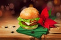 Fresh hamburger and christmas decor with poinsettia flower Royalty Free Stock Photo