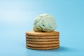 Fresh hami melon flavor ice cream on top of crackers on blue background Royalty Free Stock Photo
