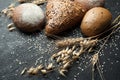 Fresh hand made bread, ear and grain on a black background Royalty Free Stock Photo
