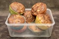 Fresh hand made muffins in transparent box on dark wooden background Royalty Free Stock Photo