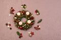 Fresh handmade Christmas wreath decorated with red and gold Christmas decorations, fir-cones and walnuts with gold candles Royalty Free Stock Photo