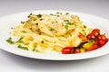 Fresh handmade tagliatelle pasta with forest mushrooms, parsley and cherry tomatoes salad Royalty Free Stock Photo